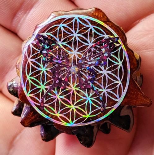 Butterfly over flower of life with opal